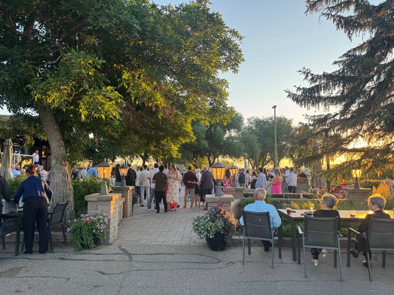 Guests gathered in a garden courtyard at golden hour